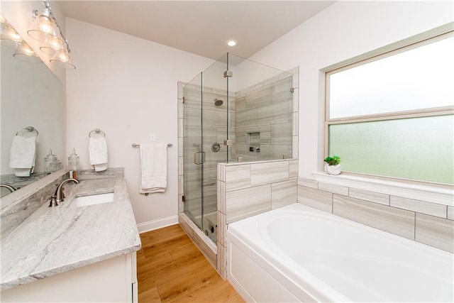201 Belle Pointe Dr, Madisonville, LA 70447 - full bath with a shower stall, a garden tub, baseboards, vanity, and wood finished floors