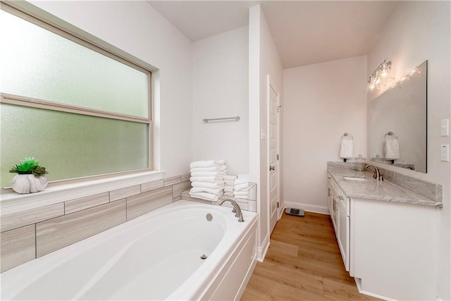 201 Belle Pointe Dr, Madisonville, LA 70447 - full bathroom featuring vanity, a bath, wood finished floors, and baseboards
