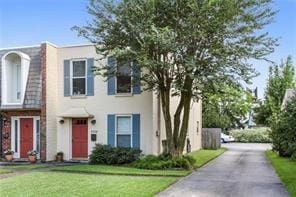 5004-0606 Newlands St, Metairie, LA 70006 - view of front facade featuring a front yard and stucco siding