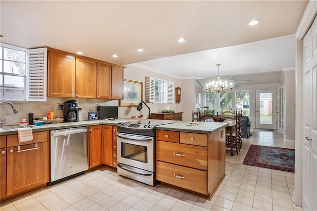 5004-0606 Newlands St, Metairie, LA 70006 - kitchen with tasteful backsplash, an inviting chandelier, a peninsula, stainless steel appliances, and a sink