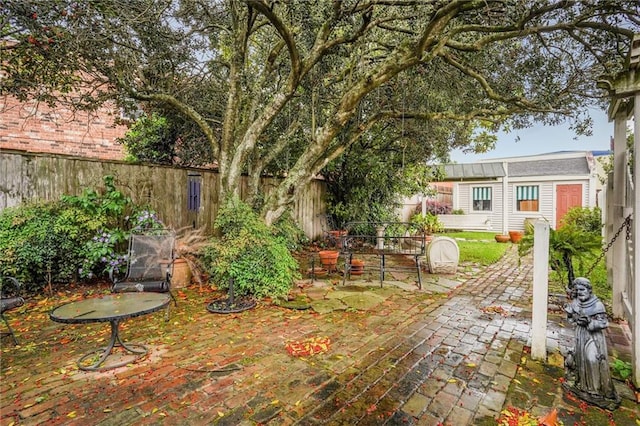 5004-0606 Newlands St, Metairie, LA 70006 - view of yard featuring a fenced backyard, an outdoor structure, and a patio