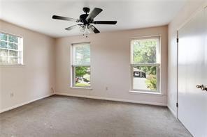 5004-0606 Newlands St, Metairie, LA 70006 - empty room with a wealth of natural light, carpet flooring, baseboards, and a ceiling fan