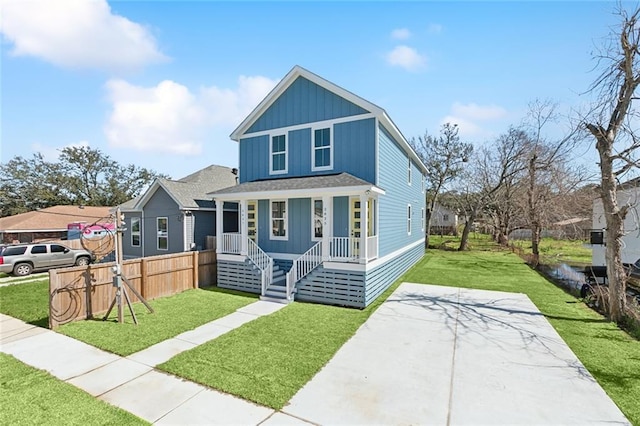 2825-27 Spain St, New Orleans, LA 70122 - view of front of home with a front yard, covered porch, board and batten siding, fence, and concrete driveway