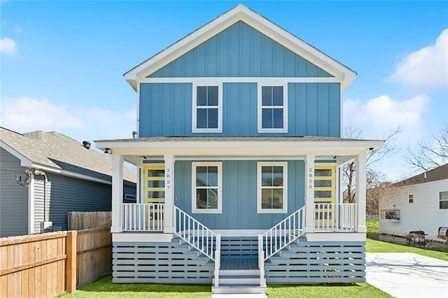 2825-27 Spain St, New Orleans, LA 70122 - view of front of home featuring board and batten siding, covered porch, and fence