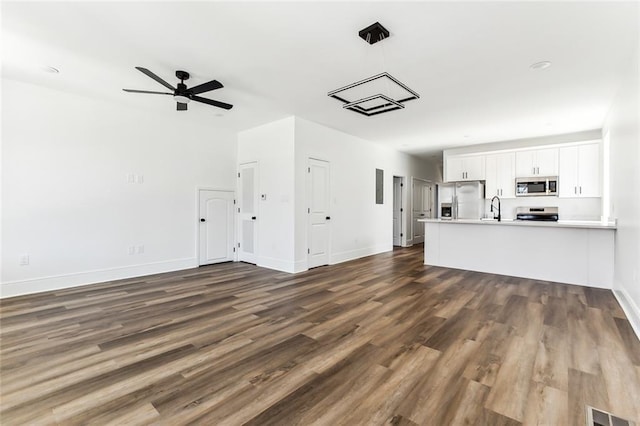 2825-27 Spain St, New Orleans, LA 70122 - unfurnished living room featuring baseboards, dark wood finished floors, visible vents, ceiling fan, and a sink