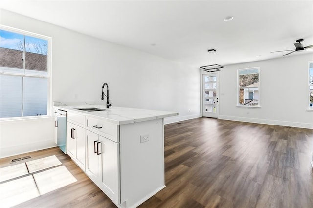 2825-27 Spain St, New Orleans, LA 70122 - kitchen with dishwasher, a sink, open floor plan, wood finished floors, and light stone counters