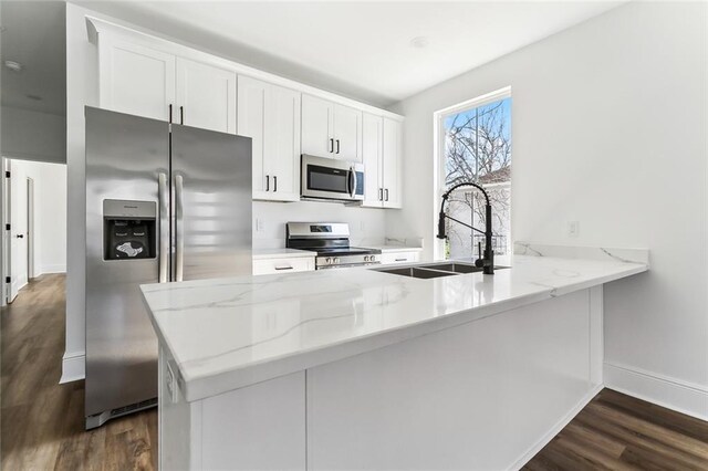 2825-27 Spain St, New Orleans, LA 70122 - kitchen with a sink, dark wood-style floors, light stone counters, and stainless steel appliances