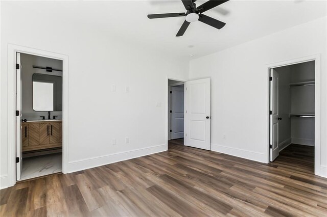 2825-27 Spain St, New Orleans, LA 70122 - unfurnished bedroom with wood finished floors, a sink, and baseboards