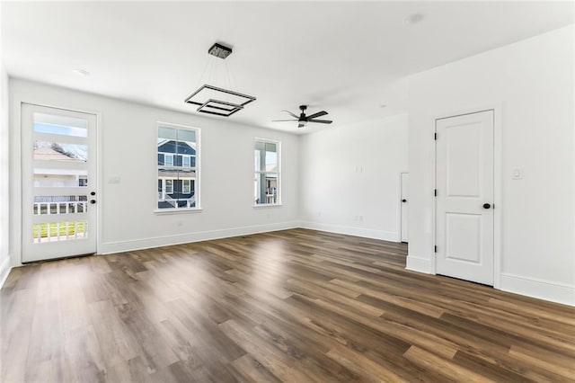 2825-27 Spain St, New Orleans, LA 70122 - unfurnished living room featuring baseboards, a ceiling fan, and dark wood finished floors
