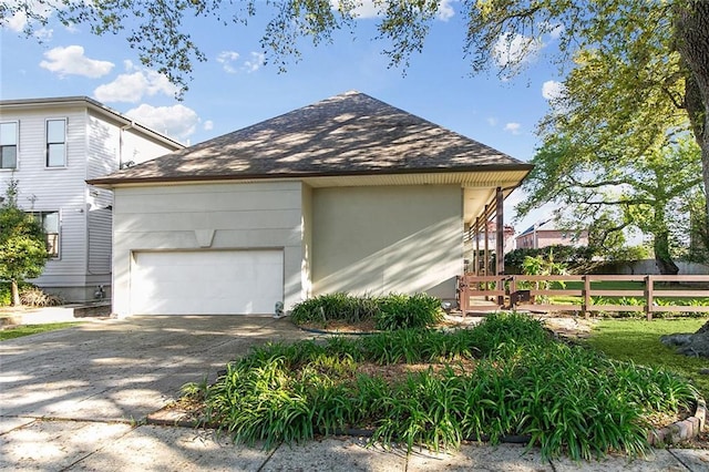 405 14th St, New Orleans, LA 70124 - view of home's exterior with a garage, driveway, fence, and a shingled roof
