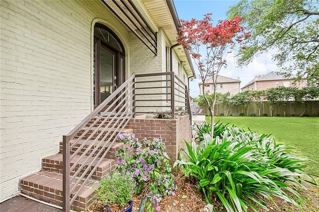 405 14th St, New Orleans, LA 70124 - entrance to property featuring brick siding, fence, and a lawn