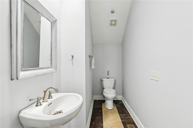 405 14th St, New Orleans, LA 70124 - half bath with toilet, visible vents, a sink, and baseboards