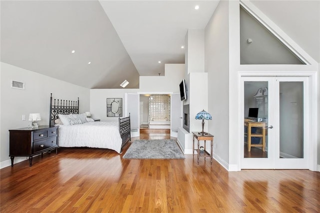 405 14th St, New Orleans, LA 70124 - bedroom featuring baseboards, french doors, visible vents, high vaulted ceiling, and light wood finished floors