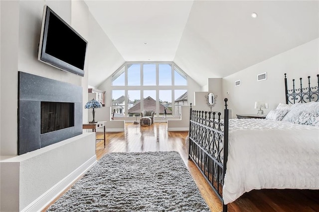 405 14th St, New Orleans, LA 70124 - bedroom featuring visible vents, a fireplace, wood finished floors, and lofted ceiling