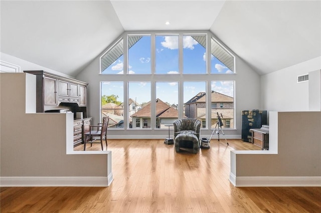 405 14th St, New Orleans, LA 70124 - living area featuring high vaulted ceiling, visible vents, and wood finished floors