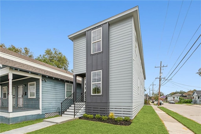 3501-03 Hamburg St, New Orleans, LA 70122 - kitchen with appliances with stainless steel finishes, a sink, light wood finished floors, a kitchen island with sink, and light stone counters