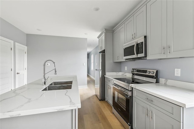 3501-03 Hamburg St, New Orleans, LA 70122 - kitchen with a sink, a ceiling fan, wood finished floors, baseboards, and a center island with sink