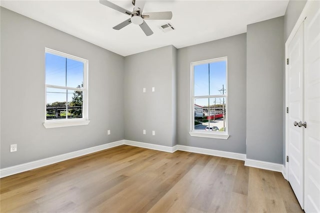 3501-03 Hamburg St, New Orleans, LA 70122 - unfurnished bedroom featuring multiple windows, light wood-type flooring, and a spacious closet