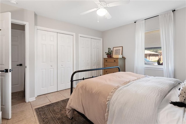 7800 Allison Rd, New Orleans, LA 70126 - bedroom featuring multiple closets, ceiling fan, light tile patterned flooring, and baseboards