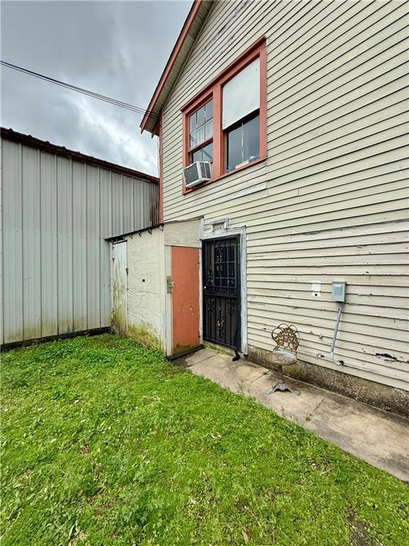 351517 Tulane Ave, New Orleans, LA 70119 - property entrance featuring cooling unit, a yard, and fence