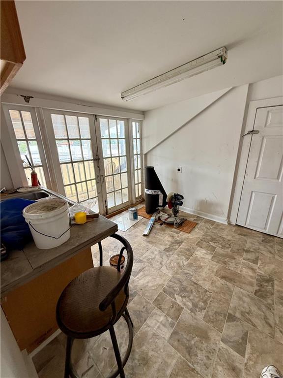 351517 Tulane Ave, New Orleans, LA 70119 - living area with french doors and stone finish flooring