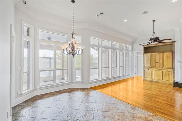 unfurnished dining area featuring crown molding, inlaid floor details, ceiling fan, a chandelier, and recessed lighting
