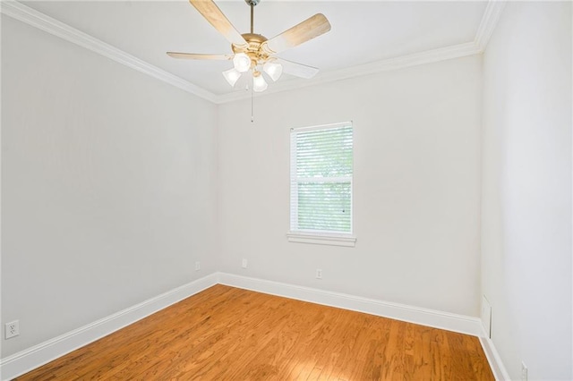 empty room featuring baseboards, light wood finished floors, crown molding, and a ceiling fan