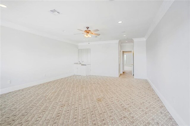 empty room featuring recessed lighting, ornamental molding, a ceiling fan, light carpet, and baseboards