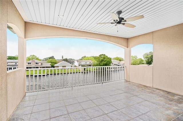 view of patio / terrace featuring a ceiling fan and a water view