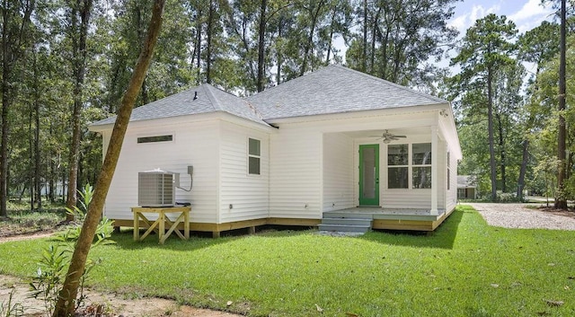 1128 W 19th Ave, Covington, LA 70433 - rear view of house with roof with shingles, central air condition unit, ceiling fan, and a lawn