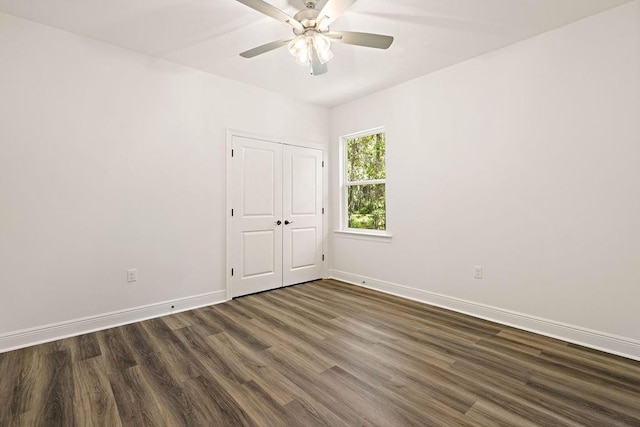 1128 W 19th Ave, Covington, LA 70433 - unfurnished room with dark wood-style floors, ceiling fan, and baseboards