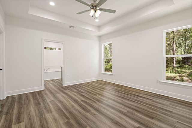 1128 W 19th Ave, Covington, LA 70433 - spare room with a tray ceiling, dark wood finished floors, baseboards, recessed lighting, and ceiling fan