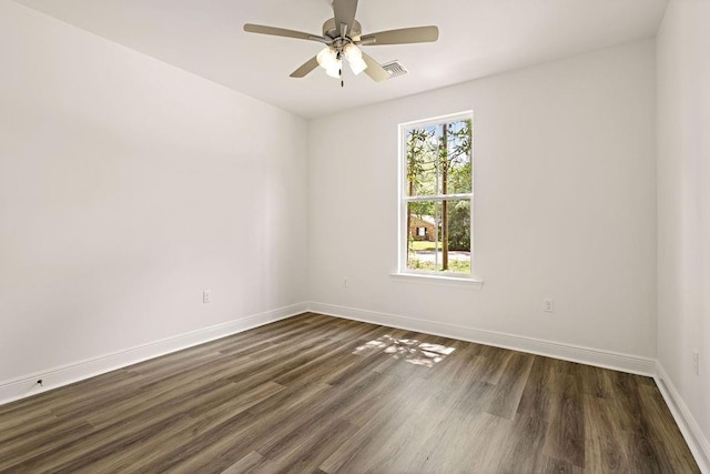 1128 W 19th Ave, Covington, LA 70433 - spare room featuring baseboards, dark wood finished floors, and a ceiling fan