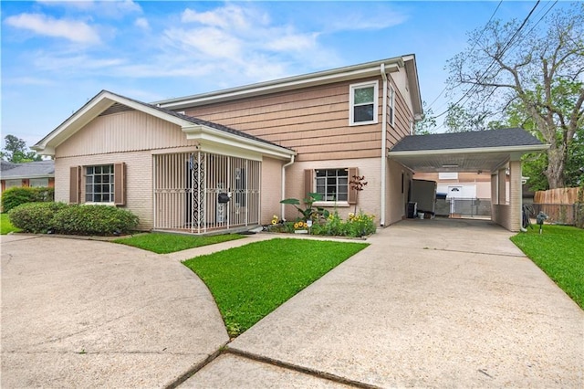 800 Marguerite Rd, Metairie, LA 70003 - view of front of home featuring brick siding, driveway, and a carport