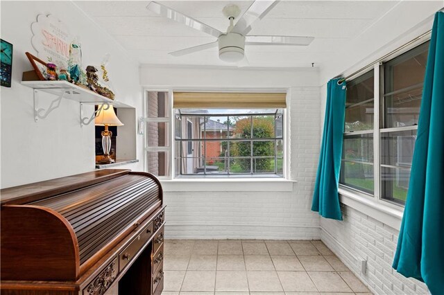 800 Marguerite Rd, Metairie, LA 70003 - bedroom featuring brick wall, light tile patterned flooring, and a ceiling fan