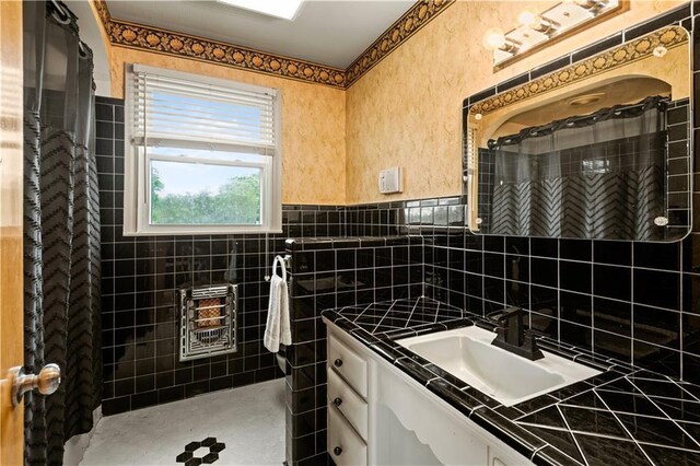 800 Marguerite Rd, Metairie, LA 70003 - bathroom with vanity, a shower with curtain, tile walls, and wainscoting