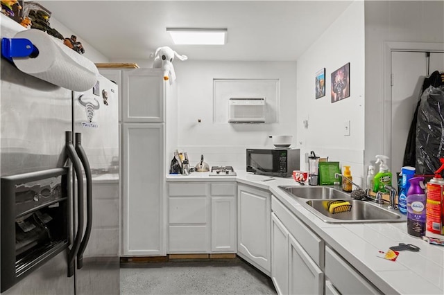 800 Marguerite Rd, Metairie, LA 70003 - kitchen with stainless steel fridge with ice dispenser, black microwave, a sink, light countertops, and white cabinetry