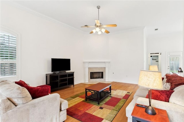 2424 Cours Carson St, Mandeville, LA 70448 - living area featuring ceiling fan, crown molding, light wood-type flooring, and a fireplace with flush hearth