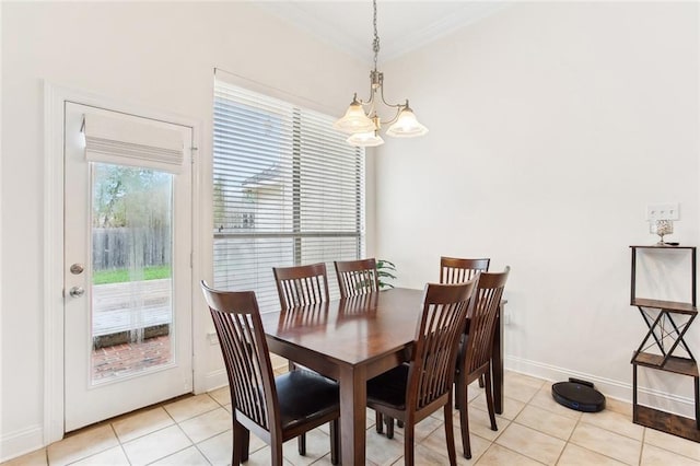 2424 Cours Carson St, Mandeville, LA 70448 - dining area with a chandelier, light tile patterned floors, crown molding, and baseboards