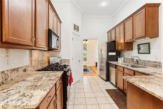 2424 Cours Carson St, Mandeville, LA 70448 - kitchen featuring appliances with stainless steel finishes, a sink, light tile patterned floors, brown cabinets, and light stone countertops
