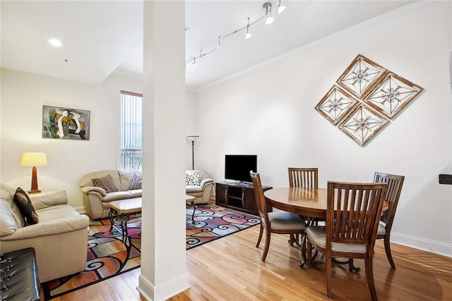 330 Julia St Unit 223, New Orleans, LA 70130 - dining area featuring wood finished floors, ornamental molding, and rail lighting