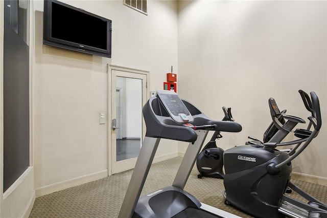 330 Julia St Unit 223, New Orleans, LA 70130 - exercise area featuring baseboards and carpet