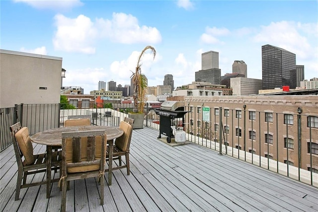 330 Julia St Unit 223, New Orleans, LA 70130 - deck with a grill, a skyline view, and outdoor dining space