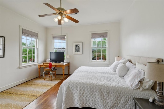 4008 Vendome Pl, New Orleans, LA 70125 - bedroom with multiple windows, baseboards, ornamental molding, and wood finished floors