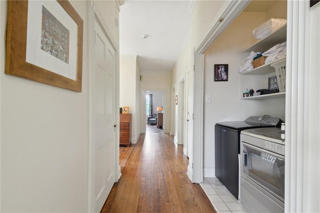 4008 Vendome Pl, New Orleans, LA 70125 - hallway featuring wood finished floors, baseboards, ornamental molding, and washer and clothes dryer