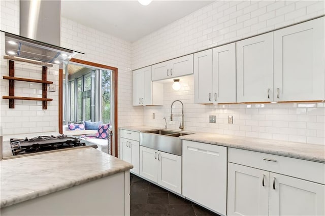 kitchen featuring wall chimney range hood, backsplash, a sink, and dishwasher