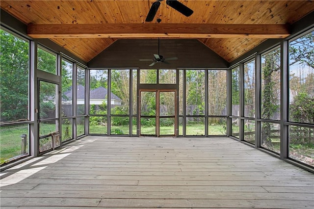 unfurnished sunroom featuring beamed ceiling and a ceiling fan