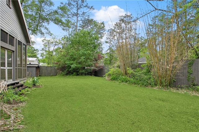 view of yard with a fenced backyard