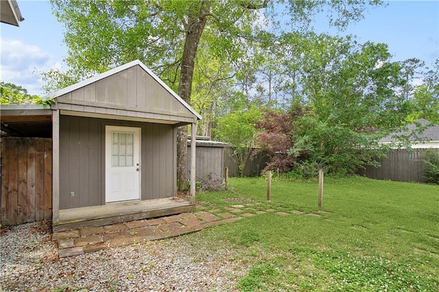 view of outbuilding with fence and an outdoor structure