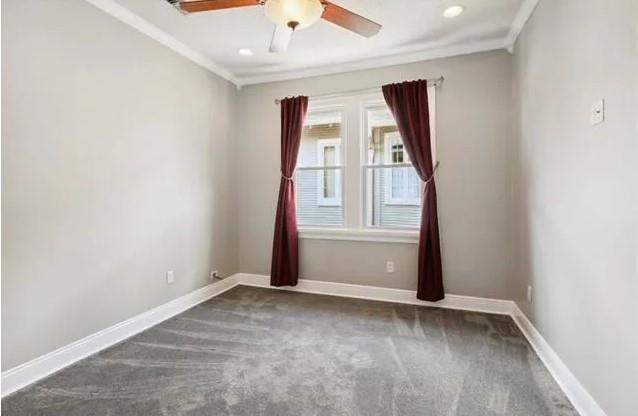 820 Solomon Pl, New Orleans, LA 70119 - carpeted spare room with crown molding, ceiling fan, and baseboards